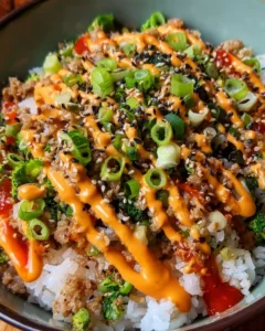 Bang Bang Ground Turkey Rice Bowls served in a colorful bowl with fresh vegetables.