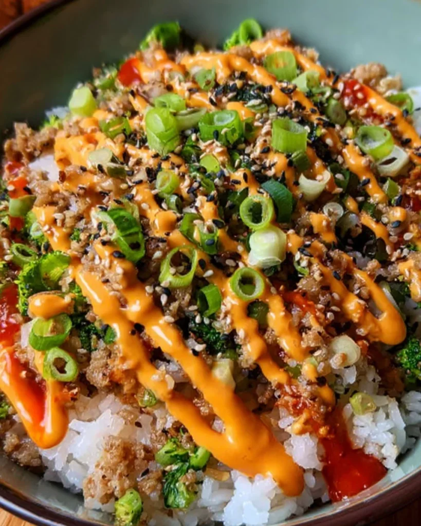 Bang Bang Ground Turkey Rice Bowls served in a colorful bowl with fresh vegetables.
