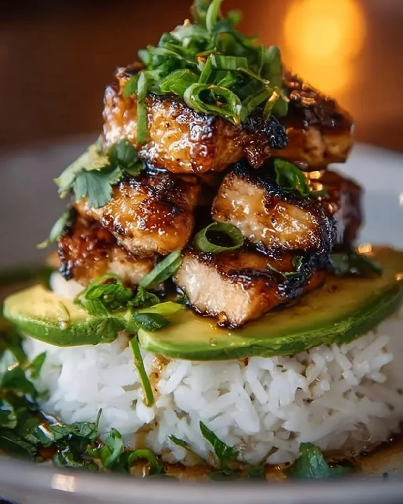 Honey lime chicken with avocado rice stack on a plate