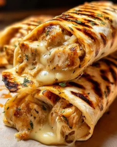 Cheesy garlic chicken wraps stuffed with gooey cheese and herbs